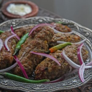Savor the flavors of grilled kebabs served with onions and green peppers on a silver platter.